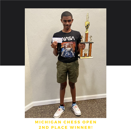 student with trophy and check